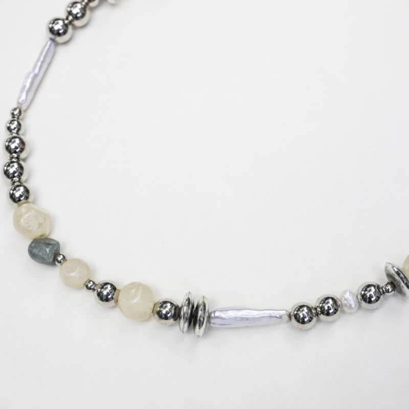 close up of silver, pearl, rock necklace