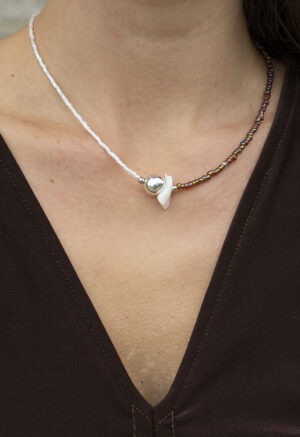 woman wearing half white half brown necklace