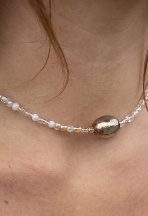 woman in black dress and beaded necklace