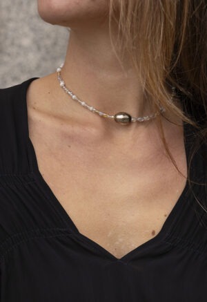 woman in black dress and beaded necklace