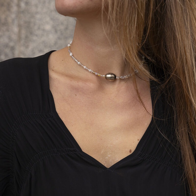 woman in black dress and beaded necklace