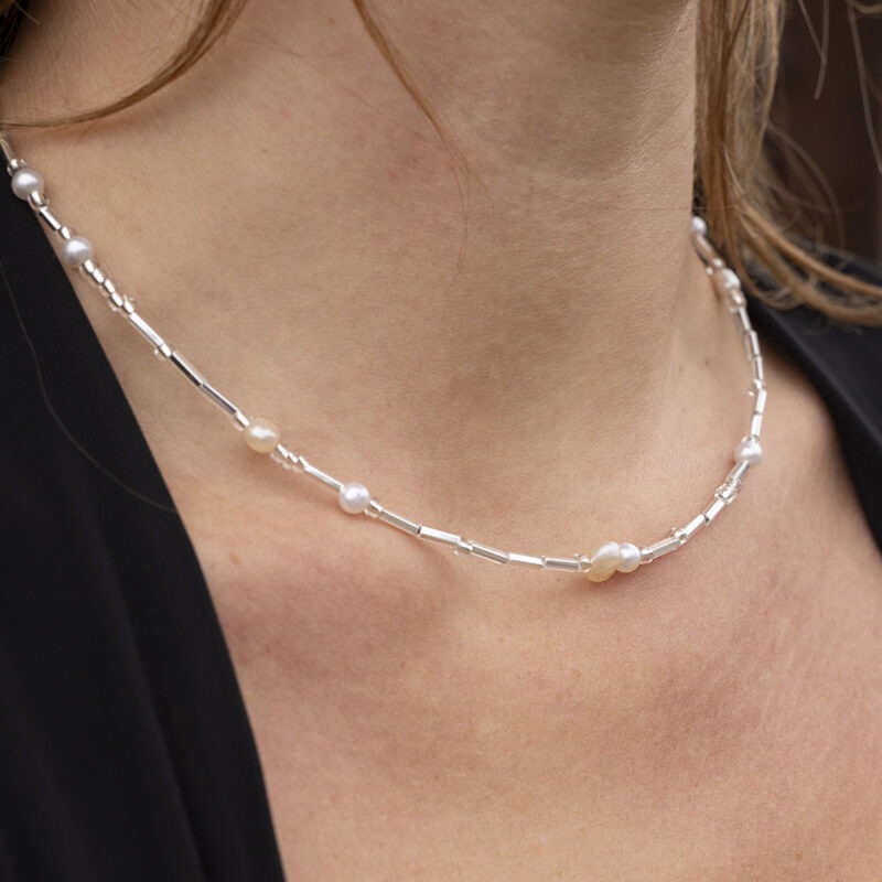 Woman in pearl and silver necklace
