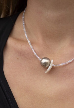 woman in black v-neck with silver and clear beaded necklace