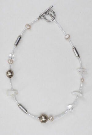 White and silver necklace of various jems
