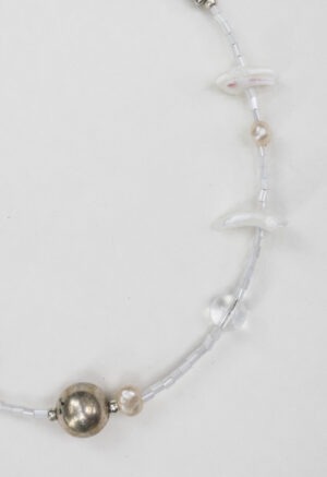 White and silver necklace of various jems