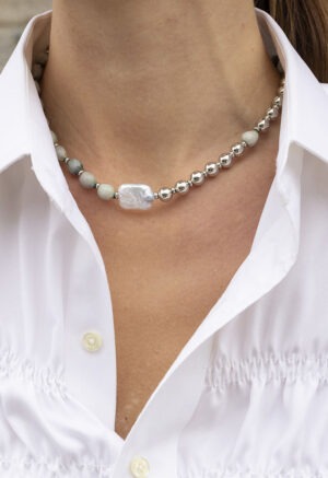 woman wearing green shell, pearl and silver bead necklace