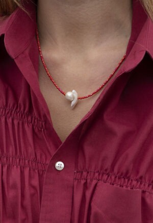 woman in red necklace with red button-up
