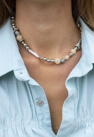 woman in silver, pearl, rock necklace