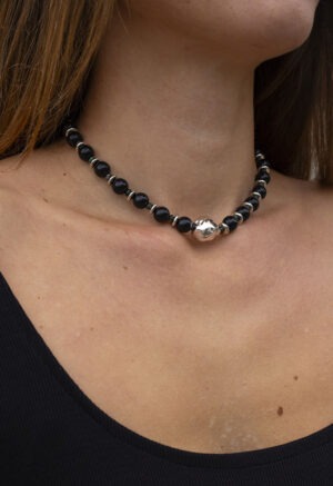 woman in black dress with black necklace