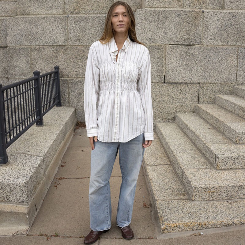 woman in white stripe button-up and jeans