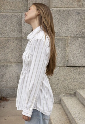 woman in white stripe button-up and jeans