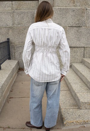 woman in white stripe button-up and jeans