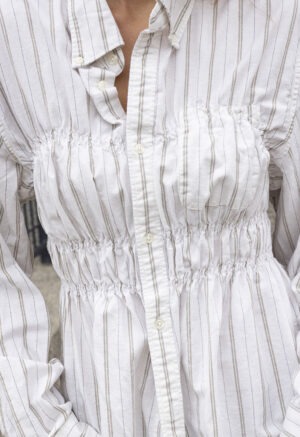 woman in white stripe button-up and jeans