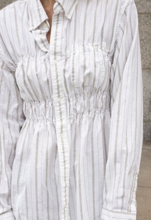 woman in white stripe button-up and jeans