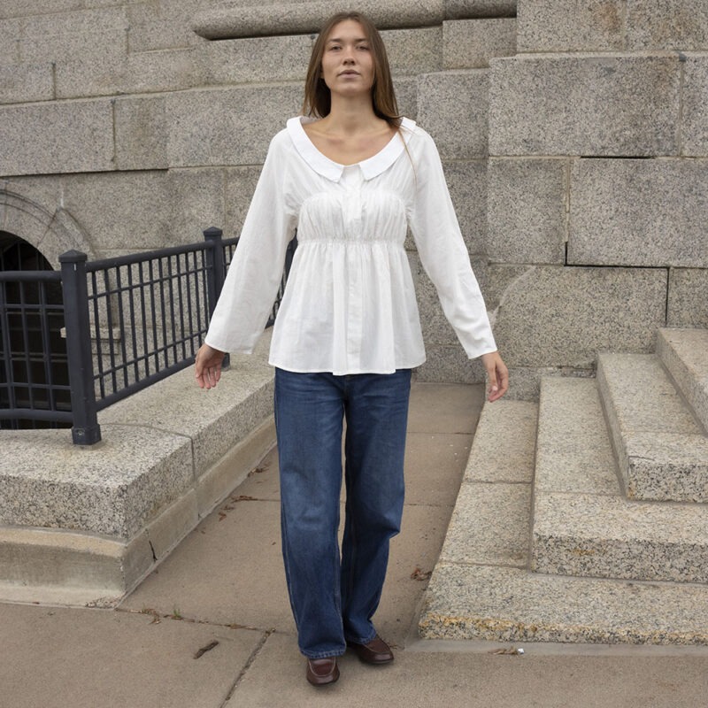 woman in white shirt and blue jeans