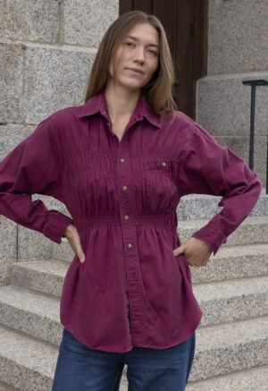 woman in maroon shirt and jeans