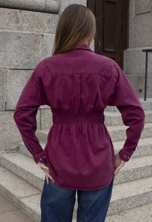 woman in maroon shirt and jeans