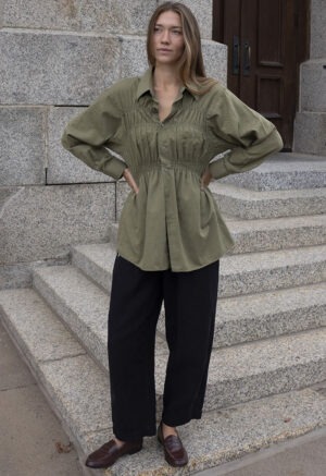 woman in green shirt and black pants