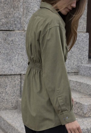 woman in green shirt and black pants
