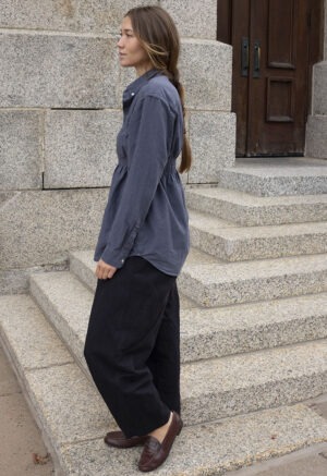 woman in dark grey button-up and black pants