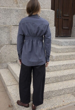 woman in dark grey button-up and black pants