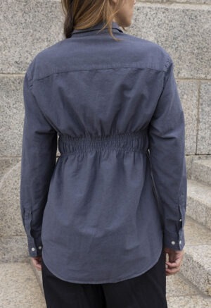 woman in dark grey button-up and black pants