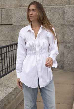woman in white button-up and jeans