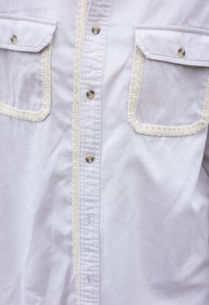woman in cream button-up and brown pants