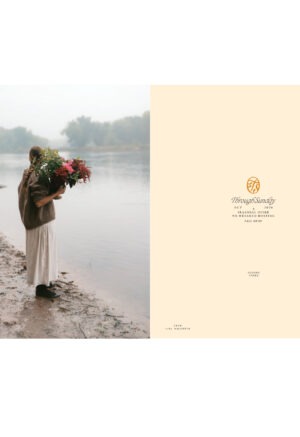 woman holding floral bouquet at a river